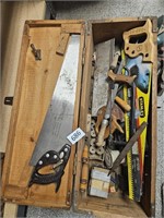 Wood box full of saws and tools
