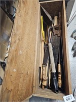 Wood box full of saws, shovels,tools