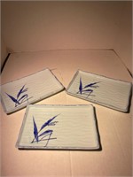 three ceramic white blue sushi plates