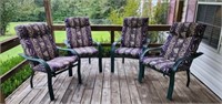 Set of four green outdoor chairs with cushions