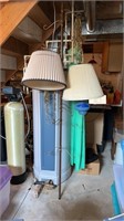 Tall tension pole with hooks and hanging lamps
