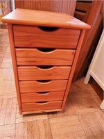 Six-drawer knotty pine rolling craft chest