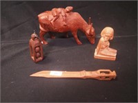 Four carved wooden items: water buffalo with man