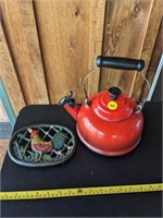 Red tea kettle and iron rooster trivet (Back