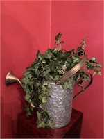 Watering can with plant