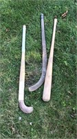 2 field hockey sticks and baseball bat