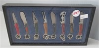 (8) Folding knives in display case. Measures: 4"