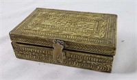 Brass-covered wooden box with small stone eggs
