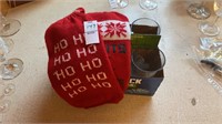 Six glass beverage glasses, two bottle cozies