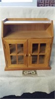 Wood cabinet with glass accents on side and door