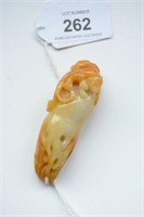Jade pendant of a qilong on a vegetable,