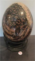Polished rock, decorative egg with stand.