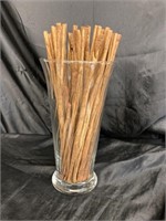 GLASS VASE FILLED WITH CINNAMON STICKS