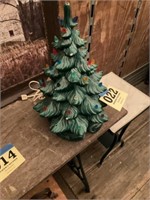 Green ceramic Christmas tree missing some lights
