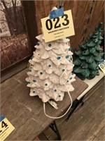 White ceramic Christmas tree missing some bulbs