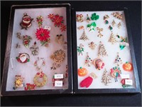 Two containers of holiday jewelry, including