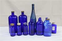 Blue glass bottles, variety of sizes and styles