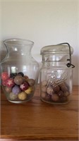 Two glass jars of marbles, one small ball jar