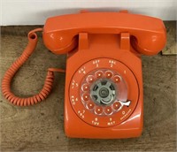 Orange rotary desk phone --Stromberg Carlson