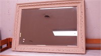 Beveled wall mirror with cream colored gesso