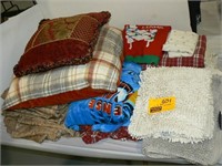 STACK OF SOFT GOODS (RUGS, PILLOWS, THROWS,
