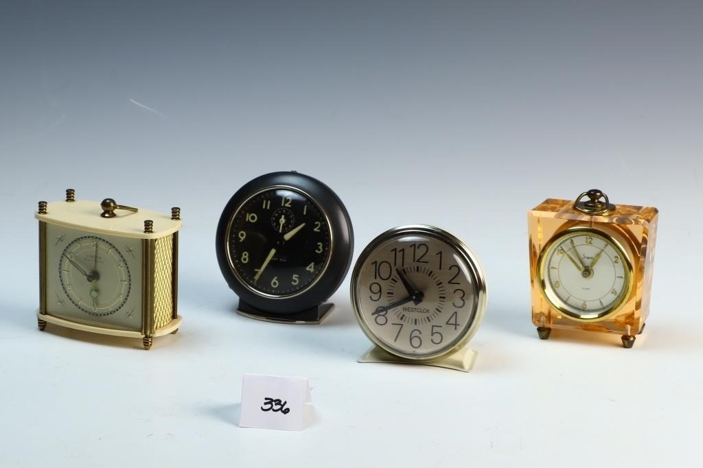 Four vintage travel clocks