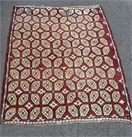 Red woven daisy rug
