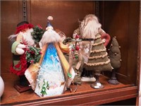 Seven soft Christmas decorations, mostly Santas,
