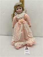 Porcelain Doll Wearing Peach Silk Dress