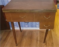 Singer sewing machine in cabinet