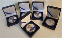 Five colorized $1 US Silver Eagles 1999 to 2003.