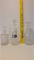 3 crystal decanters , 1 sterling decanter collar