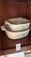 Two different size glass baking dishes with lids
