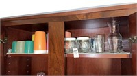 Shelf lot of cups and glass jars