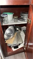 Cabinet contents such as a strainer, glass jars,