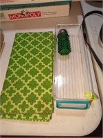 Green place mats, saltshaker, plastic bin