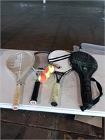 Four tennis rackets and tennis balls