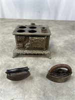 Vintage small sad irons and metal oven