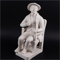 LARGE BISQUE FIGURE OF A SEATED MAN