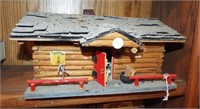 Homemade log cabin train layout building.