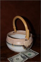 Ceramic basket with reed handle, signed