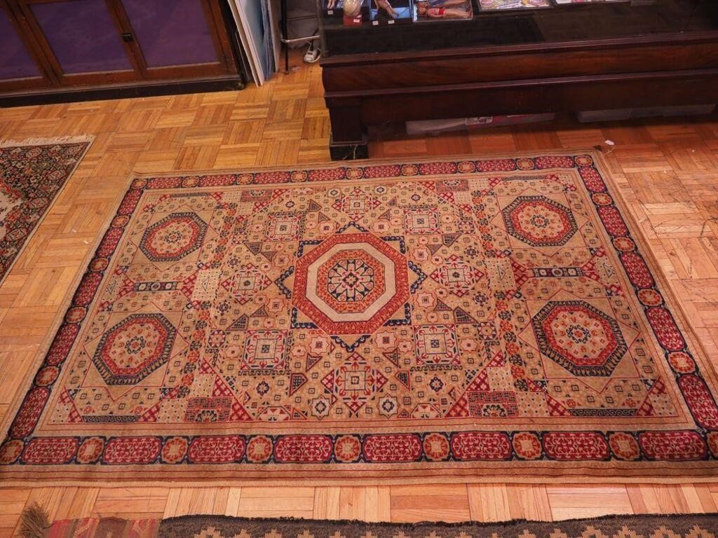 Wool rug with brown ground and red and black