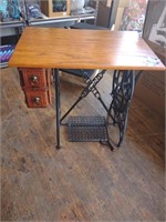 End table on an antique cast iron sewing base