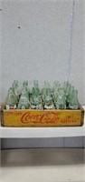 Vintage Coca-Cola wooden crate with assorted