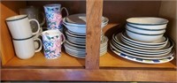 Plates saucers and cups on this shelf