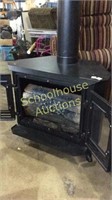 Black Metal Electric Fire Place with stove pipe.