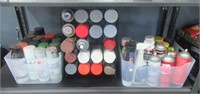 Shelf full that includes Rust oleum spray cans,