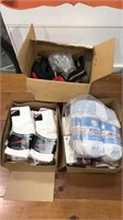 Two boxes of new socks and a box of straps for