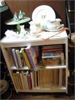 Bookshelf with cookbooks, misc kitchen decor