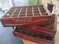 Three Coca-Cola crates